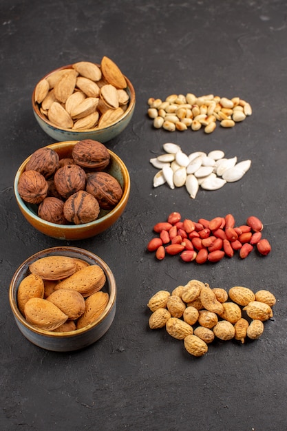 Top view of nut composition with different fresh nuts on grey surface