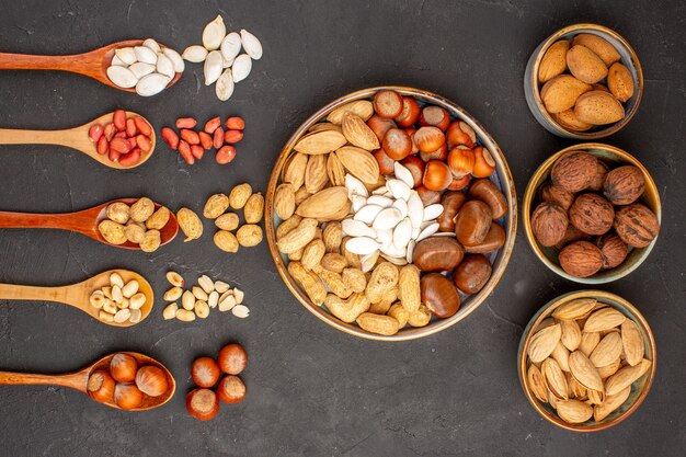 Top view of nut composition with different nuts on dark surface