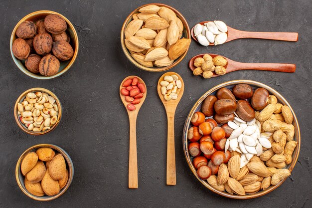 Top view of nut composition with different nuts on dark surface