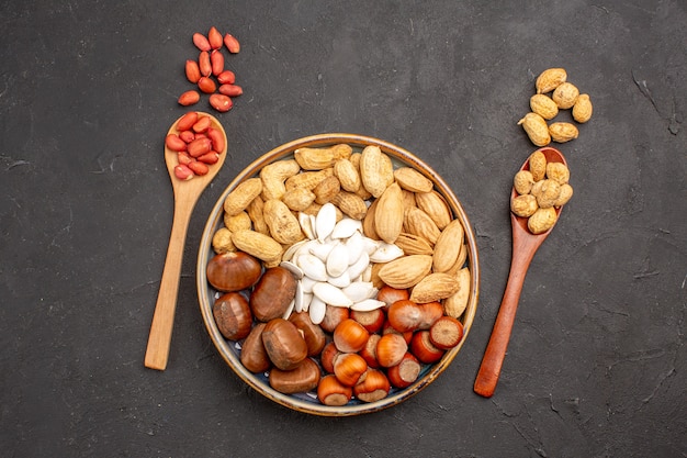 Top view of nut composition with different nuts on dark surface