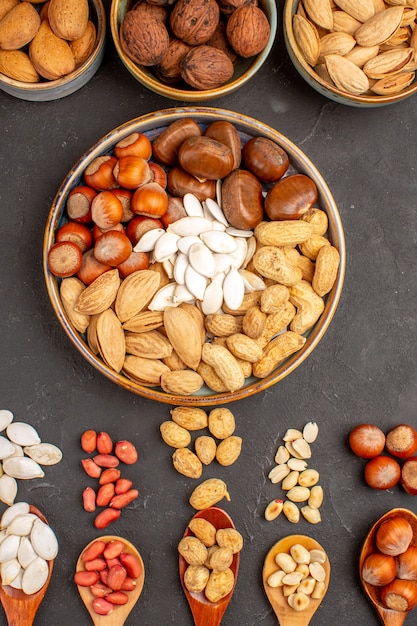 Top view of nut composition with different nuts on dark surface