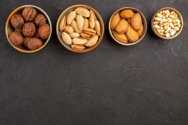 Top view of nut composition with different nuts on grey surface