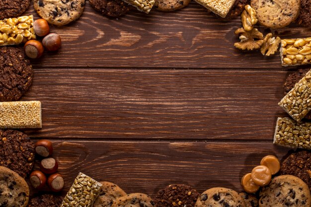 Top view of nuts and cookies with copy space on a wooden