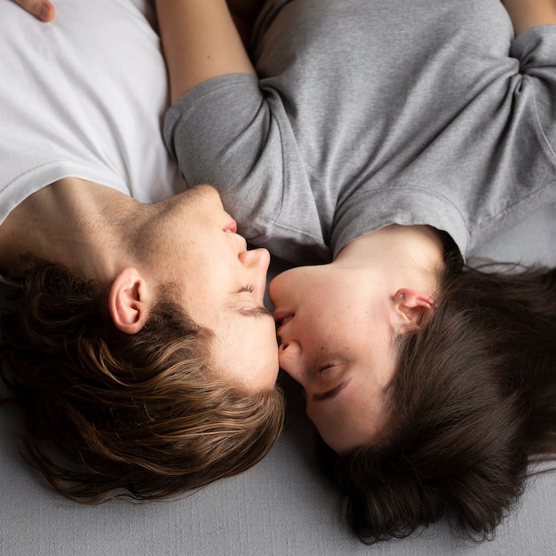 Top view o couple being intimate on sofa