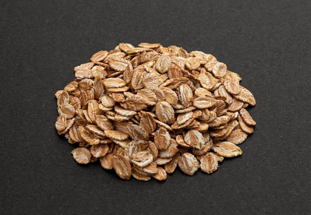 Top view of oat flakes on black background