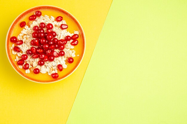 Top view of oatmeal orange bowl of oatmeal with berries