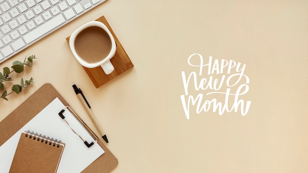 Top view office arrangement with happy new month lettering