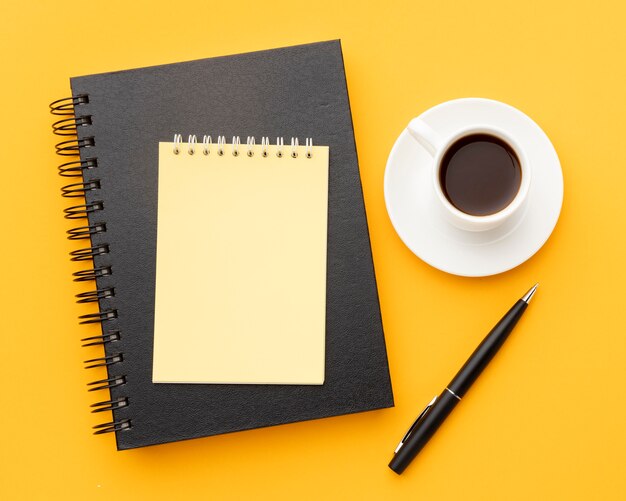 Top view office desk composition with empty notepad