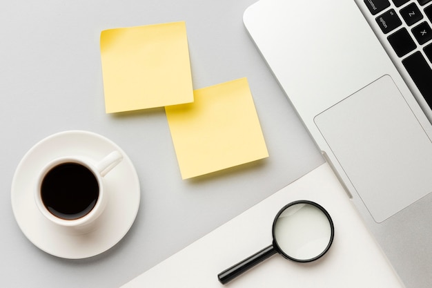 Top view office desk composition with yellow post its