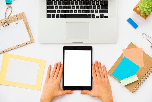 Top view of office desk with tablet mockup