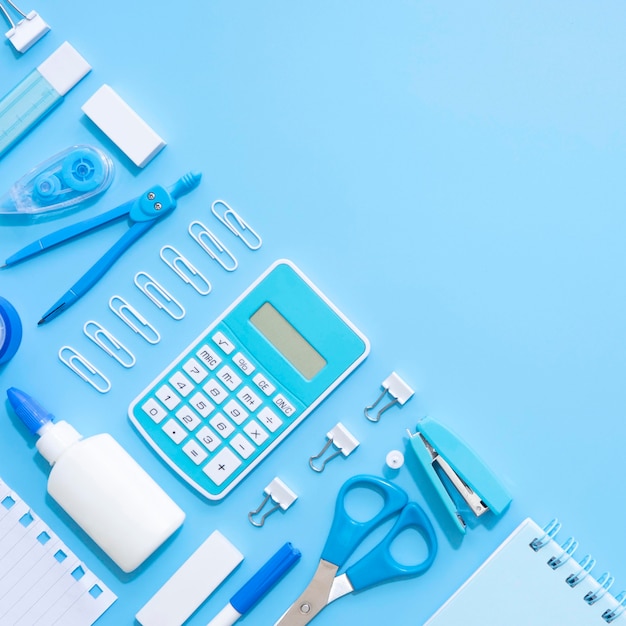 Top view of office stationery with calculator and stapler