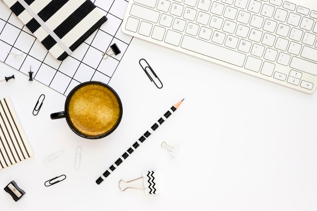 Top view of office stationery with coffee and keyboard