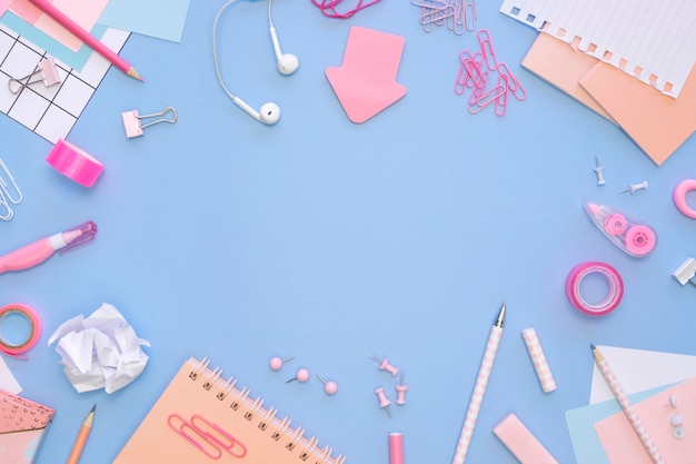 Top view of office stationery with earphones and notebooks