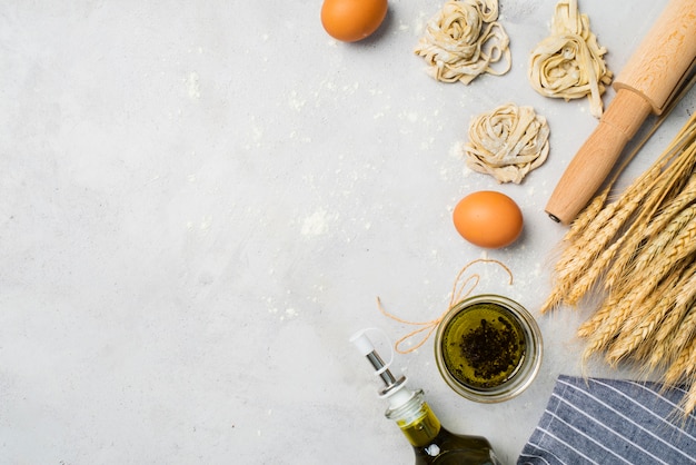 Top view olive oil and eggs on the table