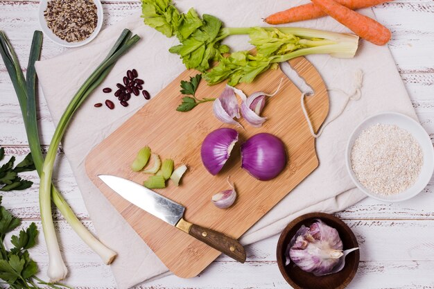 Top view of onion on chopping board with beans