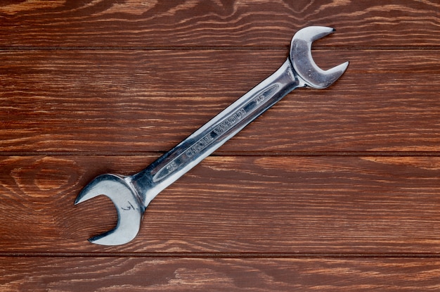 Free photo top view of open-end wrench on wooden background