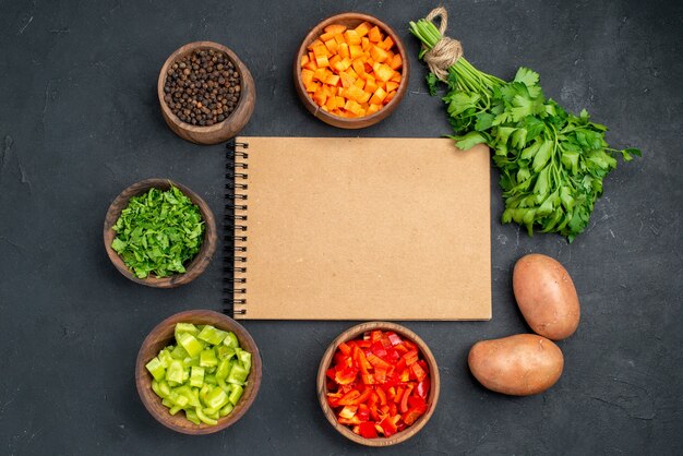 Top view of open notebook towel spoon and different spices