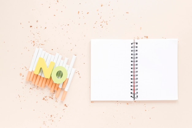 Top view open notebook with cigarettes