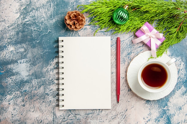 Top view open notepad with cup of tea