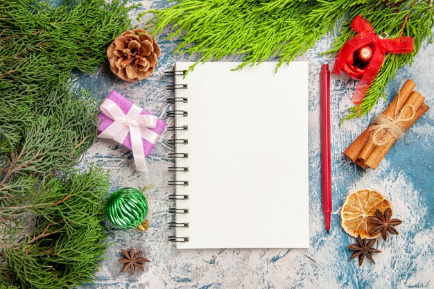 Top view open notepad with green branch