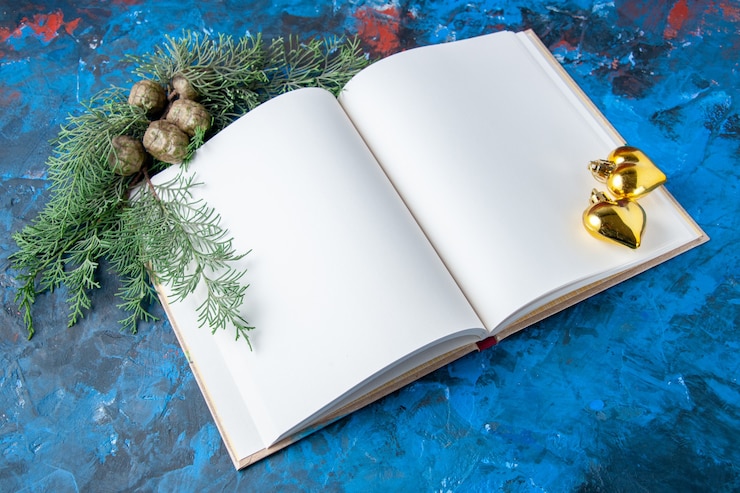 Free Photo top view opened notebook fir tree branches cones xmas tree toys on blue background free place