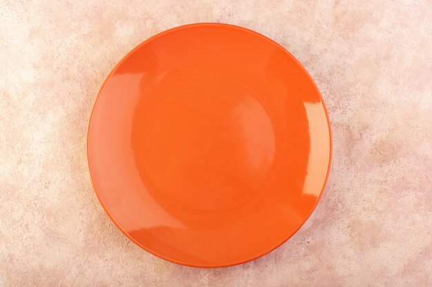 A top view orange round plate empty glass made isolated meal table