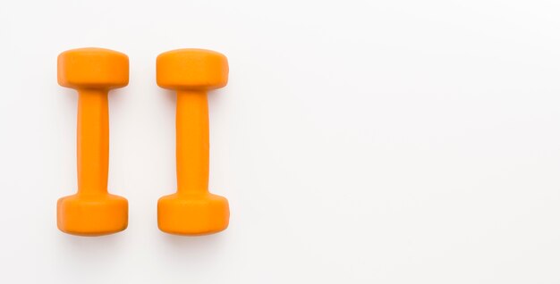 Top view of orange weights with copy space