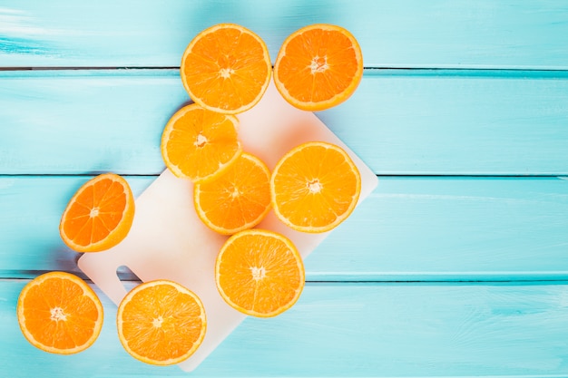 Top view oranges on wooden background