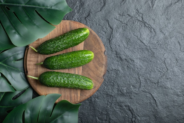 Top view of organic cucumber on wooden board