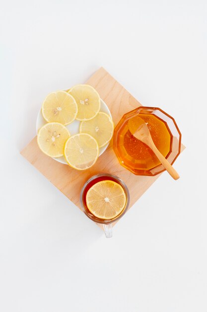 Top view organic honey with lemon slices