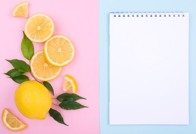 Top view organic lemon with notebook