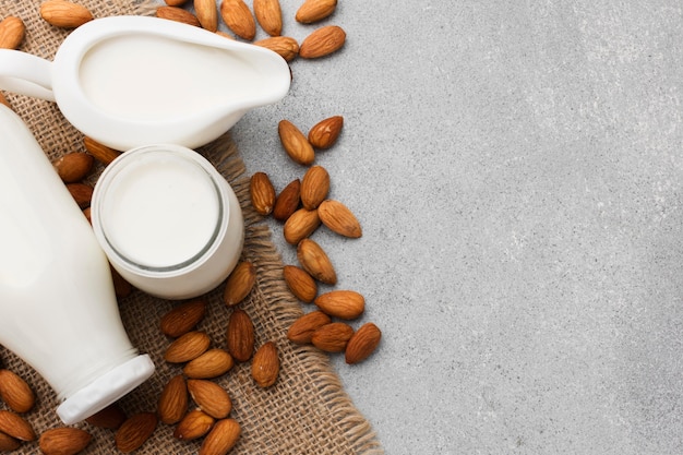 Top view organic milk and almonds with copy space