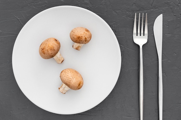 Top view organic mushrooms with cutlery