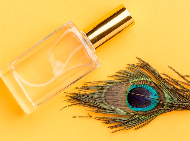 Top view organic perfume with peacock feather