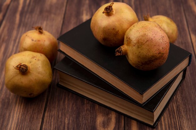 Top view of organic pomegranates isolated on a wooden surface