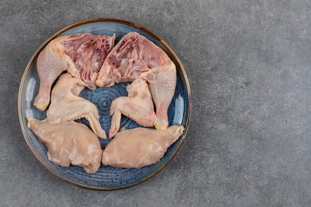 Top view of organic raw chicken meats on plate