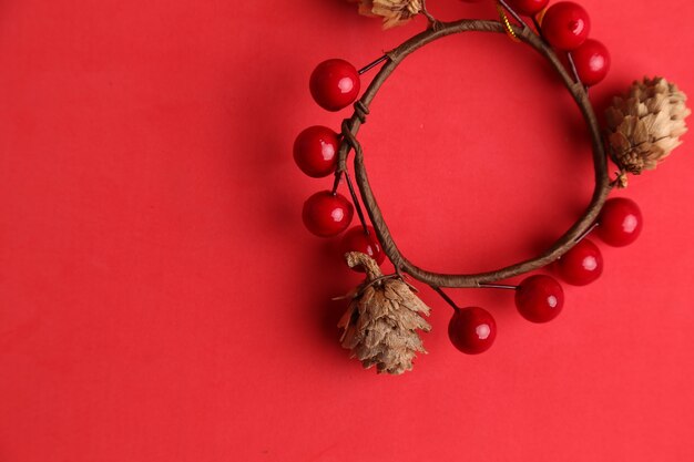 top view of ornament used for hanging on Christmas trees made of acorns and cherries