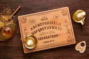 Free photo top view ouija board and cake