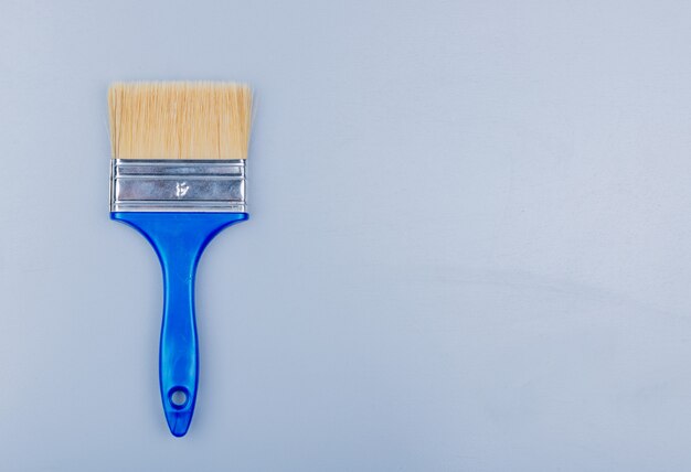 Top view of paint brush on gray background with copy space