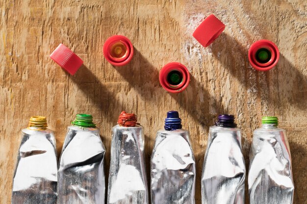 Top view of paint tubes on wooden surface