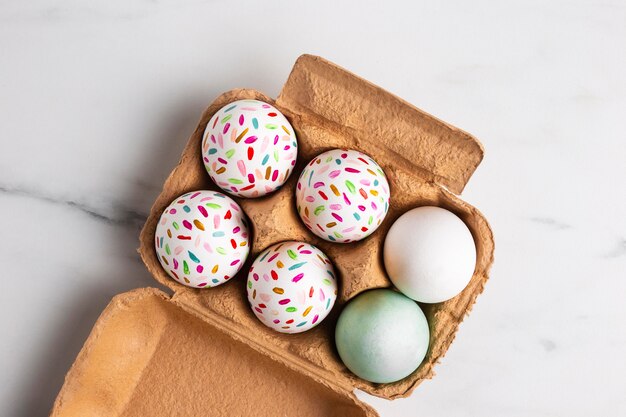 Top view of painted easter eggs in carton