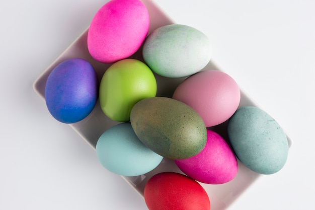 Top view of painted easter eggs on plate