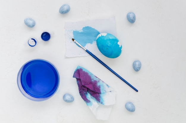 Top view of painted egg with blue dye for easter