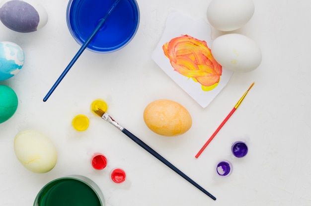 Top view of painted eggs for easter with assortment of dyes