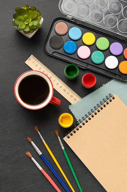 Free photo top view of painting set with palette and coffee