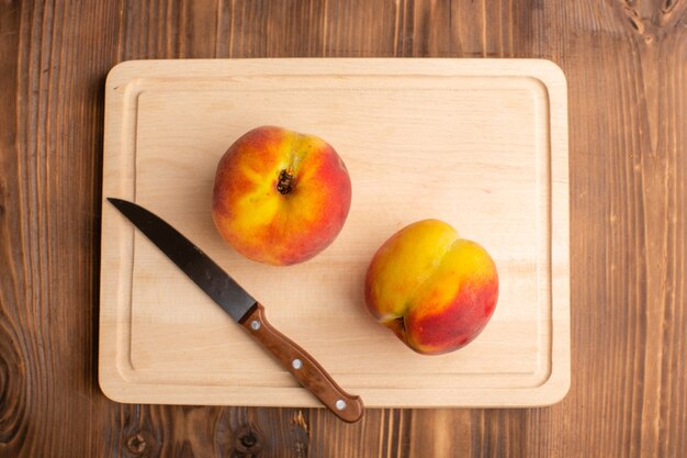 Top view of pair of peaches on the wooden surface