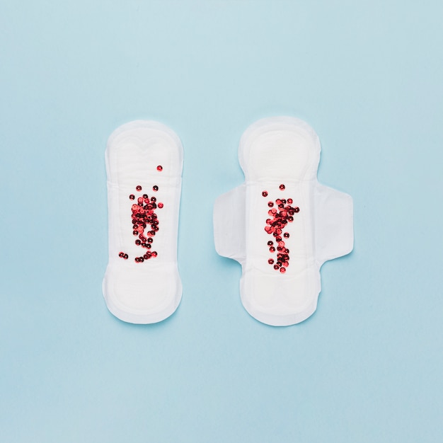 Free photo top view pair of sanitary towels with red sequins