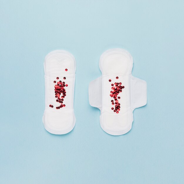 Top view pair of sanitary towels with red sequins