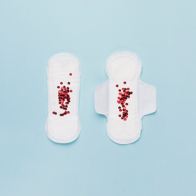 Top view pair of sanitary towels with red sequins