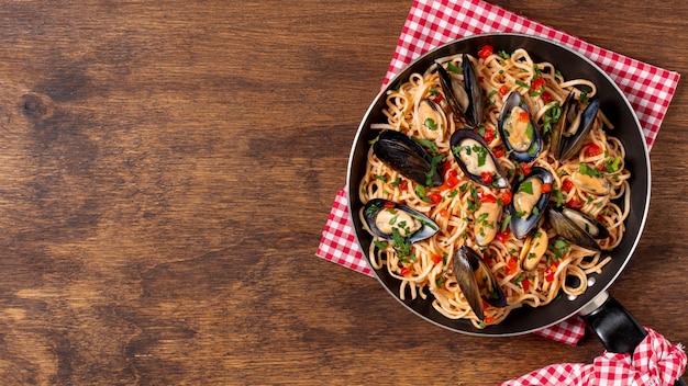 Top view pan with pasta and mussels